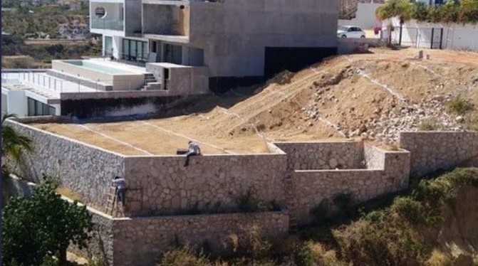 Stone retaining walls on a hillside lot